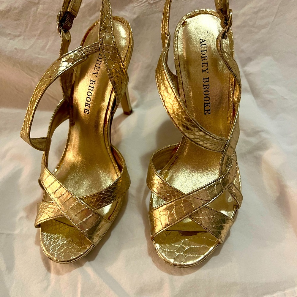 Audrey Brooke gold heeled sandals.